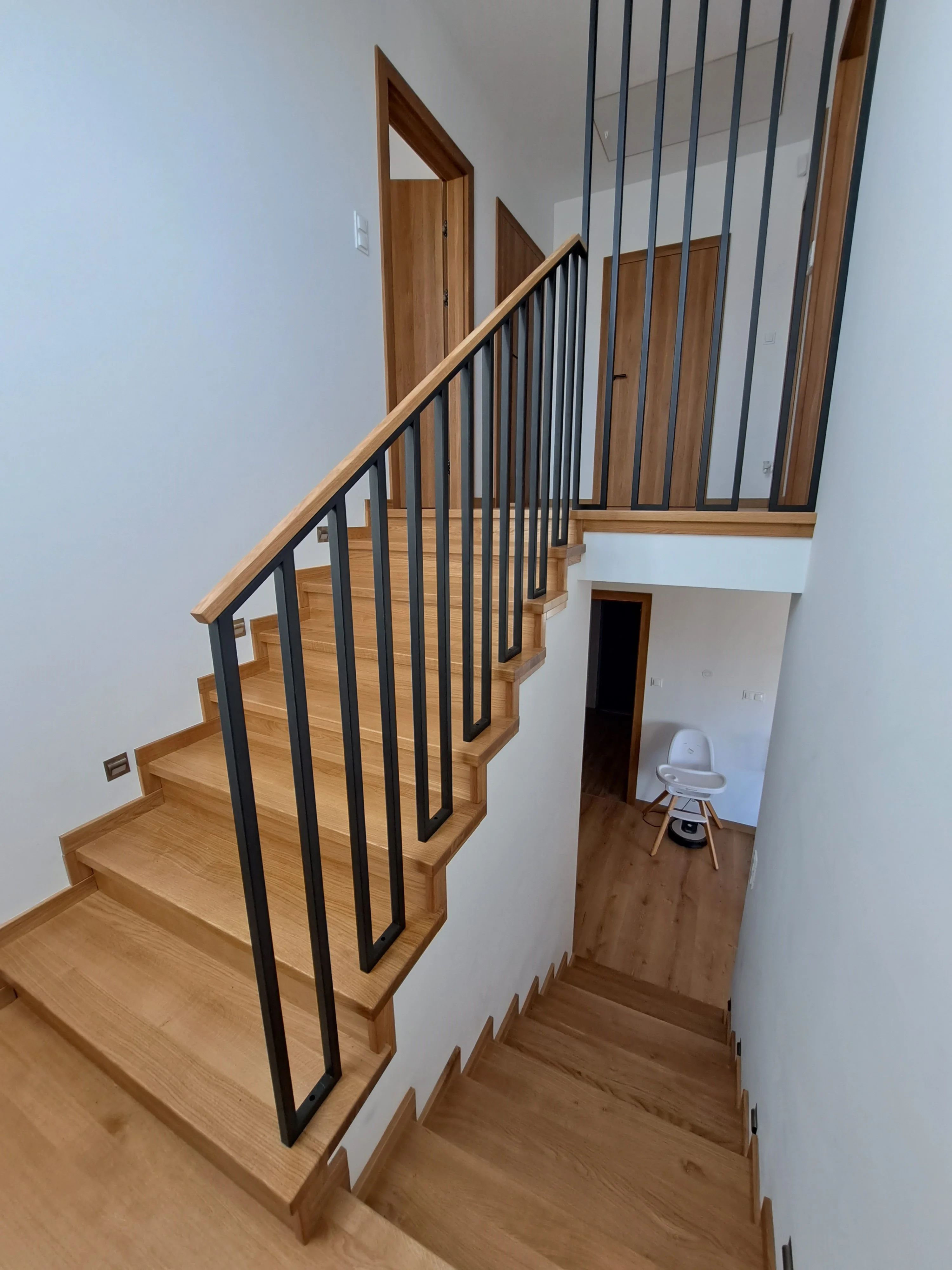 Detal stalowej balustrady malowanej przy schodach dębowych